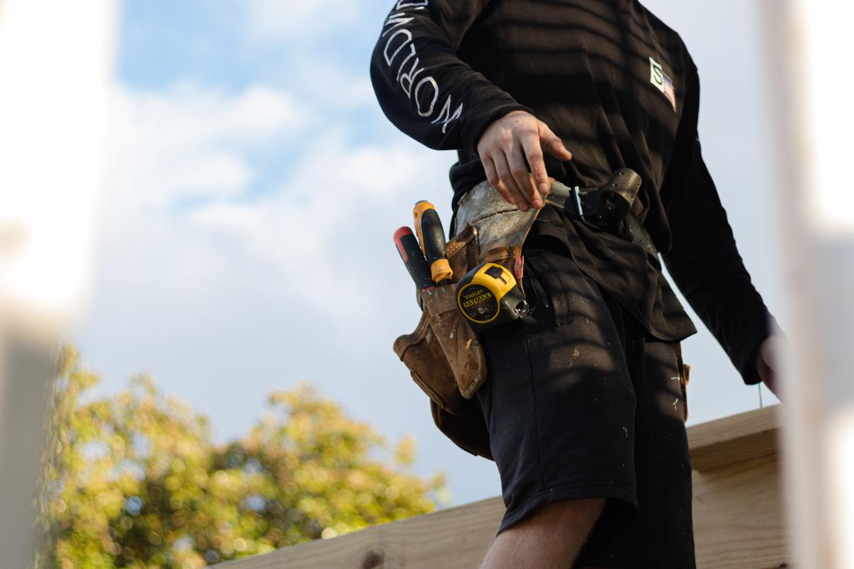 man carrying tools